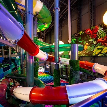 Colorful area with multi-level slides and tropical decoration